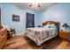 Comfortable bedroom with hardwood floors, and a large window providing plenty of natural light at 714 Sugar Camp Way, Brooksville, FL 34604