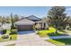 Charming single-story home with well-manicured lawn and a two-car garage at 714 Sugar Camp Way, Brooksville, FL 34604