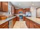 Spacious kitchen featuring stainless steel appliances, tile flooring and granite countertops at 714 Sugar Camp Way, Brooksville, FL 34604