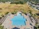 Aerial view of a large resort-style pool with palm trees, cabanas, and lounge chairs at 714 Sugar Camp Way, Brooksville, FL 34604