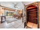 Cozy living room with comfortable seating, wine storage, and a large bay window offering abundant natural light at 7922 Flowerfield Dr, Tampa, FL 33615