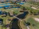 An aerial view shows a lush golf course, scenic ponds, and beautiful landscaping at 8005 Bardmoor Pl # 202I, Seminole, FL 33777