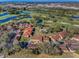 Aerial view of the community shows lush landscaping, mature trees, community pool and well-maintained condo buildings at 8005 Bardmoor Pl # 202I, Seminole, FL 33777