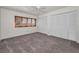 Bedroom with a ceiling fan, carpet flooring, and large closet for storage at 8005 Bardmoor Pl # 202I, Seminole, FL 33777