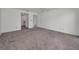 Spacious bedroom showcasing neutral paint, carpeting, and two entryways at 8005 Bardmoor Pl # 202I, Seminole, FL 33777