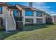 A two-story home with a balcony, large windows, lush lawn, and well-maintained landscaping at 8005 Bardmoor Pl # 202I, Seminole, FL 33777