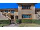 Beige, two-story condo with brown trim and manicured hedges in front at 8005 Bardmoor Pl # 202I, Seminole, FL 33777