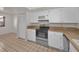 Well-maintained kitchen with white cabinets, stainless steel oven, and neutral tile floors at 8005 Bardmoor Pl # 202I, Seminole, FL 33777