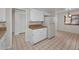 Open kitchen showcasing white cabinets, tile floors, and a vintage refrigerator at 8005 Bardmoor Pl # 202I, Seminole, FL 33777