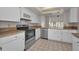 Practical kitchen features white cabinetry, stainless steel appliances, and tile floors at 8005 Bardmoor Pl # 202I, Seminole, FL 33777