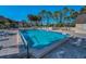 Community pool features crystal clear water, palm trees, lounge chairs, and a spa at 8005 Bardmoor Pl # 202I, Seminole, FL 33777