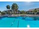 A community pool with lounge chairs and palm trees creates a resort-like atmosphere for relaxation at 8005 Bardmoor Pl # 202I, Seminole, FL 33777
