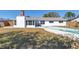 Back exterior of house and pool showing the chimney and bright white siding at 8418 Flagstone Dr, Tampa, FL 33615