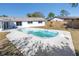 Backyard pool with concrete pool deck, landscaping, fencing, and view of home's exterior at 8418 Flagstone Dr, Tampa, FL 33615