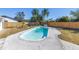 Backyard pool, fully fenced in, with a concrete pool deck, mature trees, and landscaping at 8418 Flagstone Dr, Tampa, FL 33615