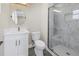 Bathroom features a shower, vanity with sink, modern lighting, and fixtures at 8418 Flagstone Dr, Tampa, FL 33615