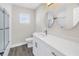 Bathroom features dual round mirrors, white vanity with quartz countertops, and tiled shower with glass door at 8418 Flagstone Dr, Tampa, FL 33615