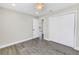 Bedroom with double closets, wood-style floors, ceiling fan, and access to hall at 8418 Flagstone Dr, Tampa, FL 33615