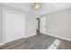 Bright bedroom features hardwood style floors, ceiling fan and double door closet at 8418 Flagstone Dr, Tampa, FL 33615