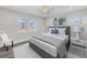 Cozy bedroom with a large window, ceiling fan, and a decorative piece over the bed at 8418 Flagstone Dr, Tampa, FL 33615