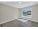 Bedroom with gray luxury vinyl flooring, neutral paint, recessed lighting and pool view at 8418 Flagstone Dr, Tampa, FL 33615