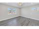 Light-filled bedroom with wood-look flooring and a view of the neighborhood at 8418 Flagstone Dr, Tampa, FL 33615