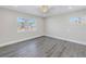 Bright bedroom with ceiling fan, large window, and wood-style floors at 8418 Flagstone Dr, Tampa, FL 33615