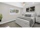 Bright bedroom with luxury vinyl floors, neutral walls, ceiling fan, and large picture window at 8418 Flagstone Dr, Tampa, FL 33615