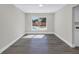 Empty dining room showcasing wood-look flooring and natural light from the backyard-facing window at 8418 Flagstone Dr, Tampa, FL 33615