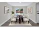 Bright dining area featuring a glass-top table and backyard view through a large window at 8418 Flagstone Dr, Tampa, FL 33615