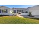 Charming single Gathering home featuring a lush front lawn, a beautiful garden, palm trees and two-car garage at 8418 Flagstone Dr, Tampa, FL 33615