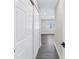 Hallway leading to bright, window-lit space, featuring wood-look flooring and white trim at 8418 Flagstone Dr, Tampa, FL 33615
