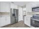 Modern kitchen featuring white cabinets, stainless steel appliances, and sleek countertops at 8418 Flagstone Dr, Tampa, FL 33615