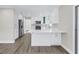 Updated kitchen with white cabinets, stainless appliances, quartz countertops, luxury vinyl plank flooring at 8418 Flagstone Dr, Tampa, FL 33615