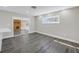 Bright living space with wood-look flooring, a stone fireplace, and a sliding glass door at 8418 Flagstone Dr, Tampa, FL 33615