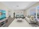 Staged living room with hardwood style floors, modern furnishings, and ample natural light at 8418 Flagstone Dr, Tampa, FL 33615