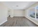 Bright living room with hardwood style floors and large windows at 8418 Flagstone Dr, Tampa, FL 33615