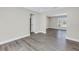 Open-concept living room with neutral walls, and a glimpse into the next room through an archway at 8418 Flagstone Dr, Tampa, FL 33615