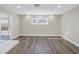 Spacious living room boasts modern recessed lighting, neutral walls, and gray-tone wood flooring at 8418 Flagstone Dr, Tampa, FL 33615