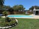 Inviting backyard pool with paver surround and beautifully landscaped flower beds at 8418 Flagstone Dr, Tampa, FL 33615