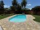 Beautiful in-ground pool with brick paver deck and tropical landscaping at 8418 Flagstone Dr, Tampa, FL 33615
