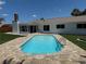Sparkling in-ground swimming pool, brick chimney, and covered patio at 8418 Flagstone Dr, Tampa, FL 33615