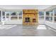 Sunroom features a stone fireplace and expansive windows overlooking the backyard at 8418 Flagstone Dr, Tampa, FL 33615