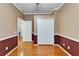 Empty bedroom has hardwood floors, white trim, and a large closet at 10322 Goldenbrook Way, Tampa, FL 33647