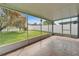 Screened lanai featuring an open backyard view with patterned tiles and a covered ceiling at 10322 Goldenbrook Way, Tampa, FL 33647