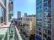 View from a condo balcony overlooking city buildings and a street with a building in the foreground on a bright day at 111 N 12Th St # 1619, Tampa, FL 33602