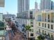View from a condo balcony overlooking city buildings and a street with a building in the foreground on a bright day at 111 N 12Th St # 1619, Tampa, FL 33602