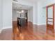 Bright open-concept living area with hardwood floors and island kitchen with modern lighting fixtures at 111 N 12Th St # 1619, Tampa, FL 33602