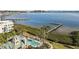 Breathtaking aerial view showcasing the community pool, long dock, and beautiful waterfront at 1203 Bay Club Cir # 1203, Tampa, FL 33607
