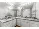 Bright bathroom featuring a dual sink vanity with marble countertop and Hollywood lighting at 1203 Bay Club Cir # 1203, Tampa, FL 33607